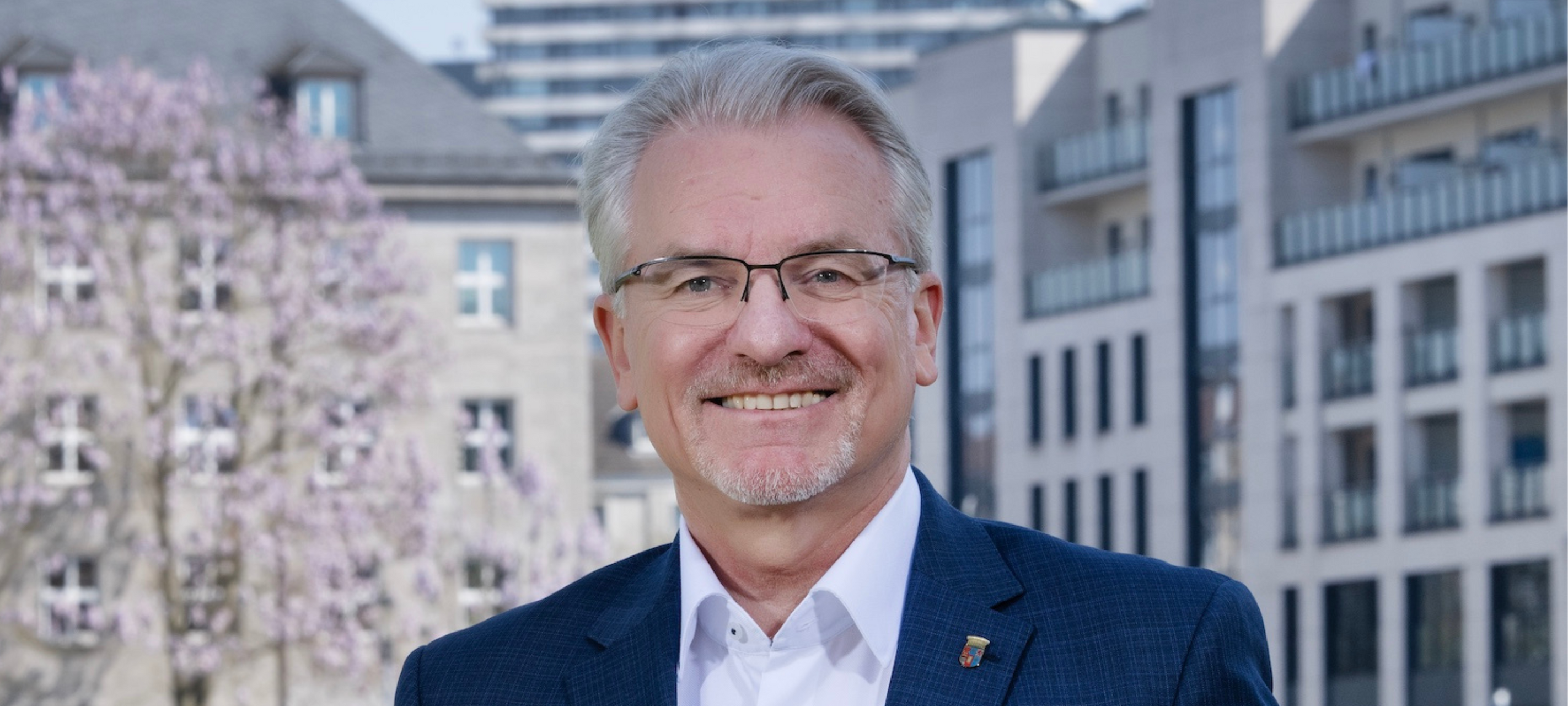 Oberbürgermeisterkandidat Marc Buchholz vor einem städtischen Hintergrund